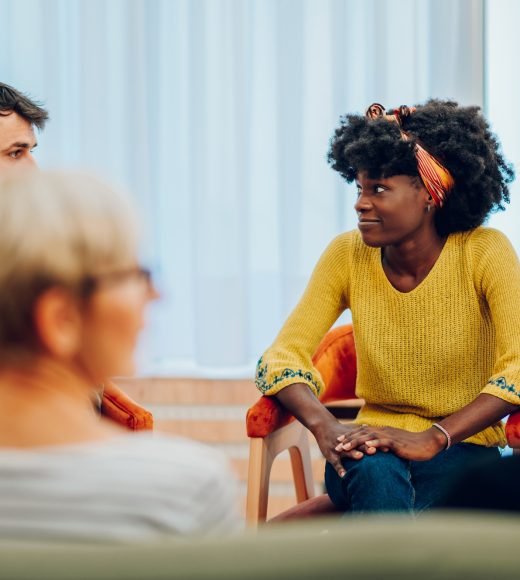 African american woman talking about her mental health on a group therapy session